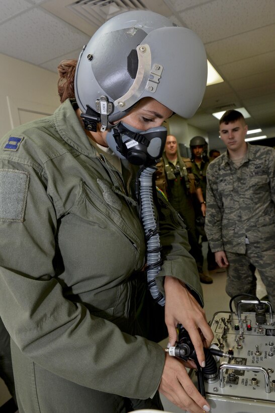 Capt. Marisa Whitaker, U.S. Air Force B-52 Stratofortress aircraft commander, 20th Expeditionary Bomb Squadron from Barksdale Air Force Base, Louisiana, performs preflight checks on her oxygen mask to ensure it is not leaking and the valves are working properly Aug. 22, 2015, at Andersen Air Force Base, Guam. Whitaker is part of an aircrew that was called upon to support ongoing operations in the Indo-Asia-Pacific region. (U.S. Air Force photo by Staff Sgt. Robert Hicks/Released)