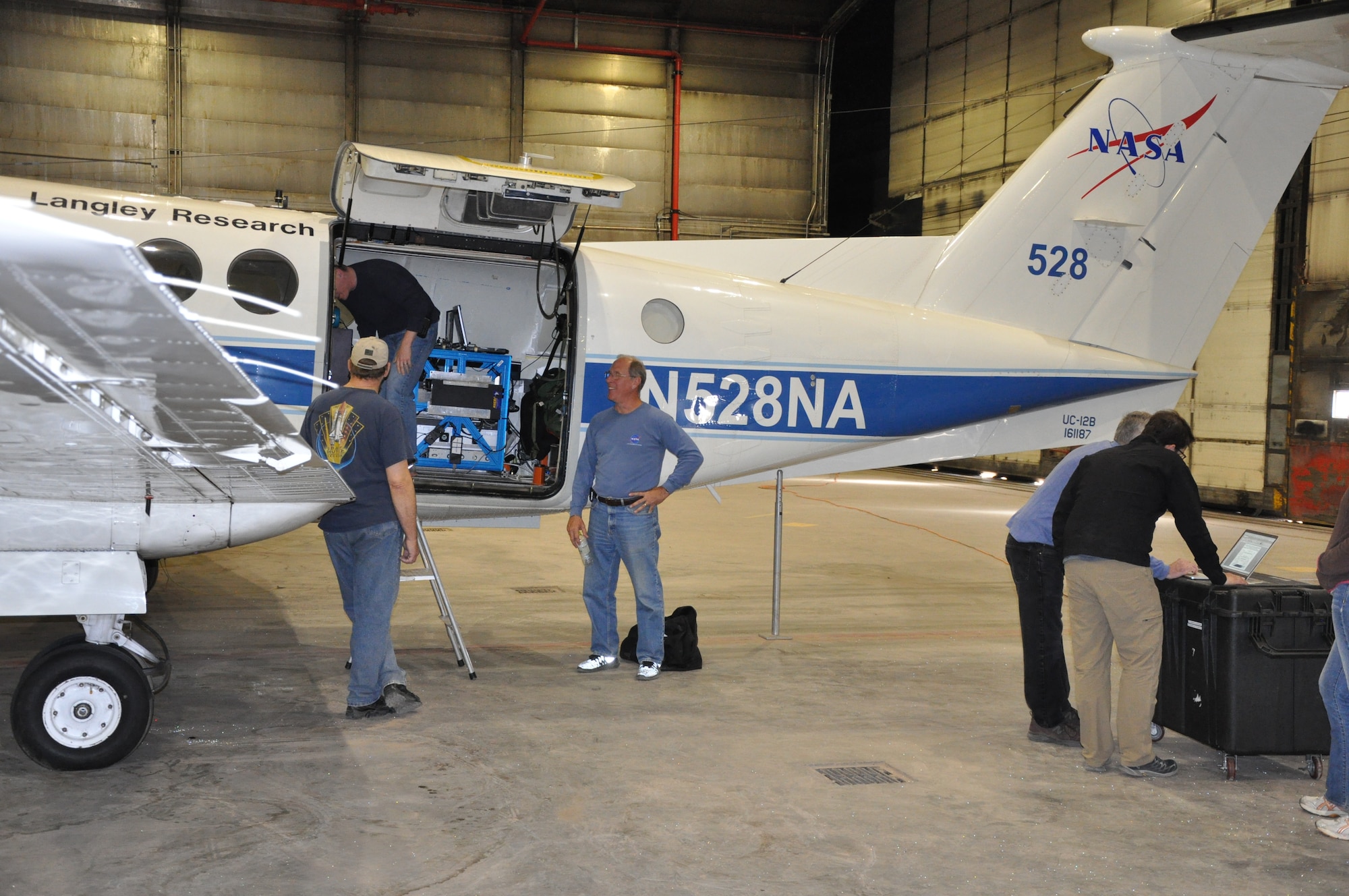 THULE AIR BASE, Greenland – Rick Yasky, a pilot with NASA’s Langley Research Center, explains features of the Beechcraft King Air aircraft Aug. 16, 2015 at Thule Air Base. The space agency recently finished three weeks of operations at Thule, developing software for a satellite due to launch in 2017. The researchers relied on the 821st Air Base Group to provide a hangar, lodging, meals and more while they conducted their research in the Arctic Circle. The 821st ABG, one of the six installations operated by the 21st Space Wing, maintains an airfield and 10,000-foot runway at the U.S. Armed Forces' northernmost installation. (U.S. Air Force photo by Steve Brady)