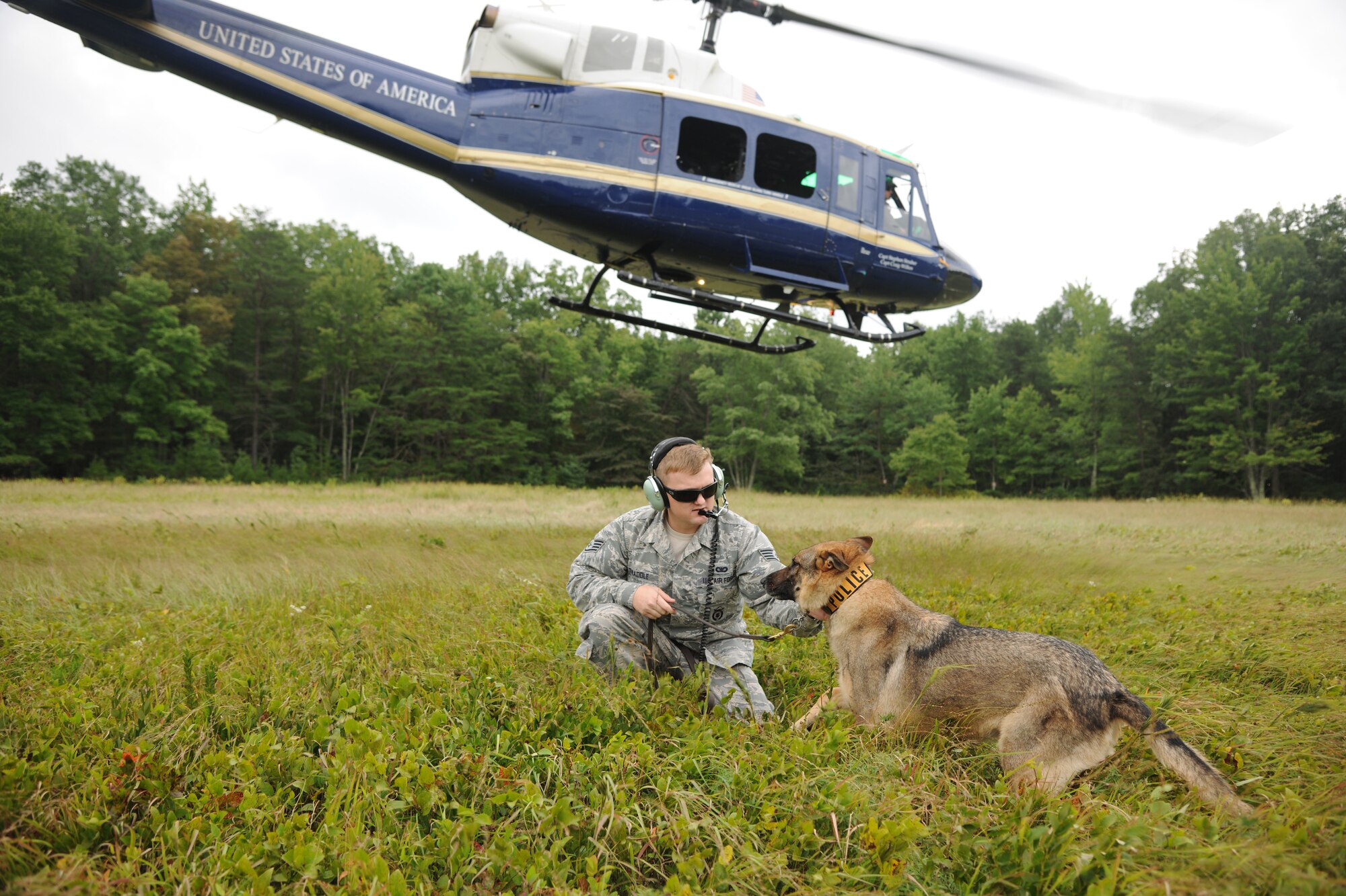 X, a military working dog, rides in a UH-1N Twin Huey helicopter over the National Capital Region, Aug. 19, 2015. Pilots from the 1st Helicopter Squadron flew the mission to get X better acclimated to helicopter noise and vibration. (U.S. Air Force photo/ Airman 1st Class J.D. Maidens)