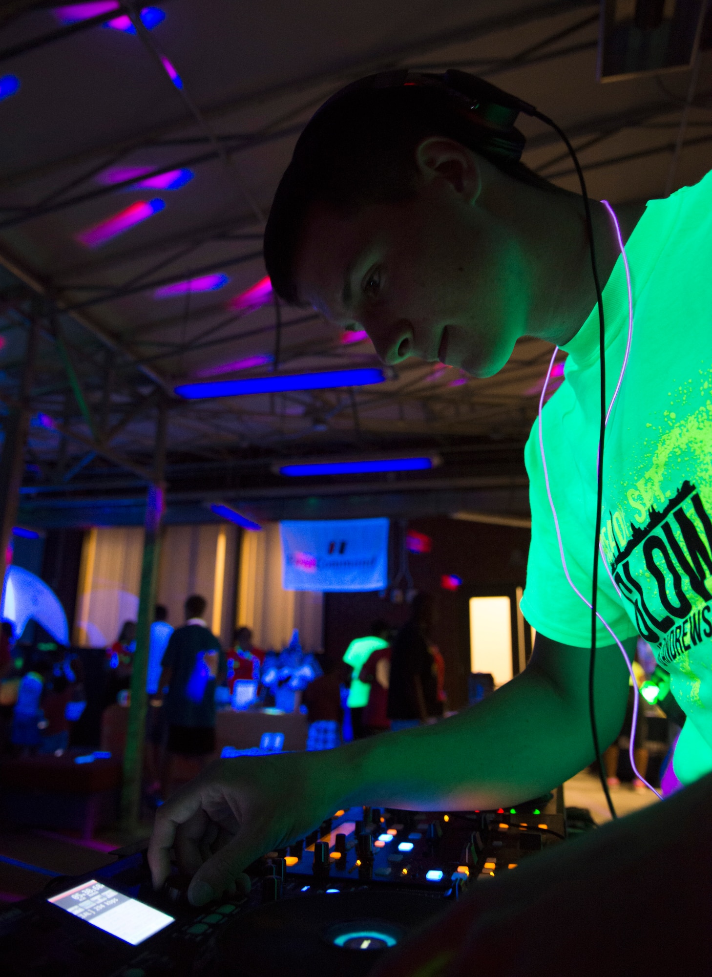 Airman Josh Krous, 11th Civil Engineer Squadron, deejays the after-party of the Ready.Set.Glow 5k inside the Community Commons on Joint Base Andrews, Md., Aug. 21, 2015. (U.S Air Force photo/Airman 1st Class Philip Bryant)