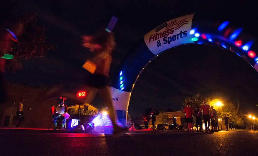Participants in the Ready.Set.Glow 5k end their run outside the Community Commons on Joint Base Andrews, Md., Aug. 21, 2015. The 5k had approximately 400 runners who wore glow sticks and neon shirts during their run around base. (U.S Air Force photo/Airman 1st Class Philip Bryant)
