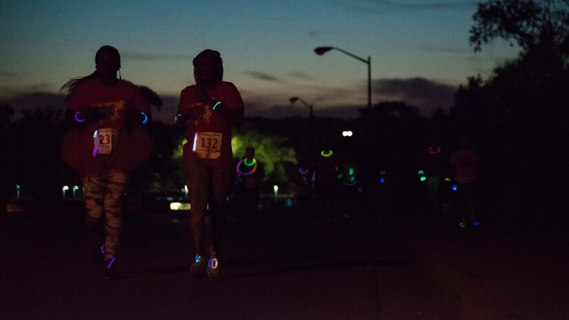 Participants in the Ready.Set.Glow 5k run down Arkansas Rd., outside the Community Commons on Joint Base Andrews, Md., Aug. 21, 2015. There were approximately 400 participants in the 5k – the fastest runner finished in 18 minutes, 48 seconds. (U.S Air Force photo/Airman 1st Class Philip Bryant)