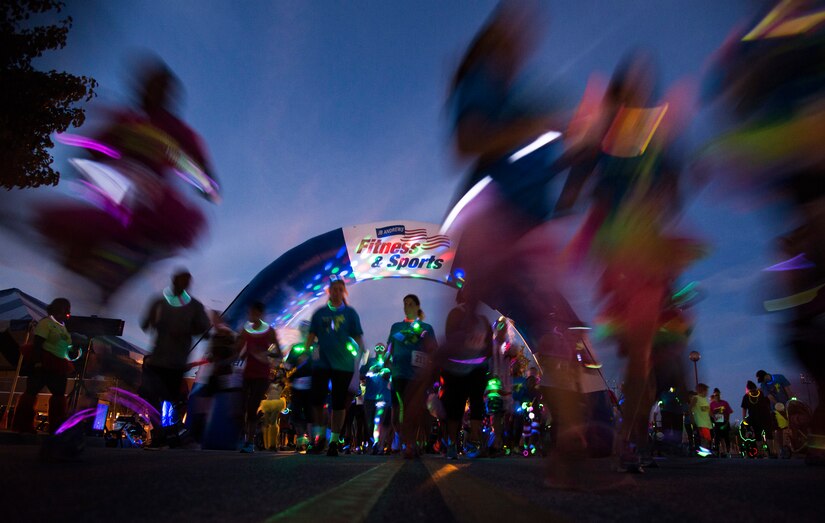 Participants in the Ready.Set.Glow 5k start their run outside the Community Commons on Joint Base Andrews, Md., Aug. 21, 2015. The 5k had approximately 400 runners who wore glow sticks and neon shirts during their run around base. (U.S Air Force photo/Airman 1st Class Philip Bryant)