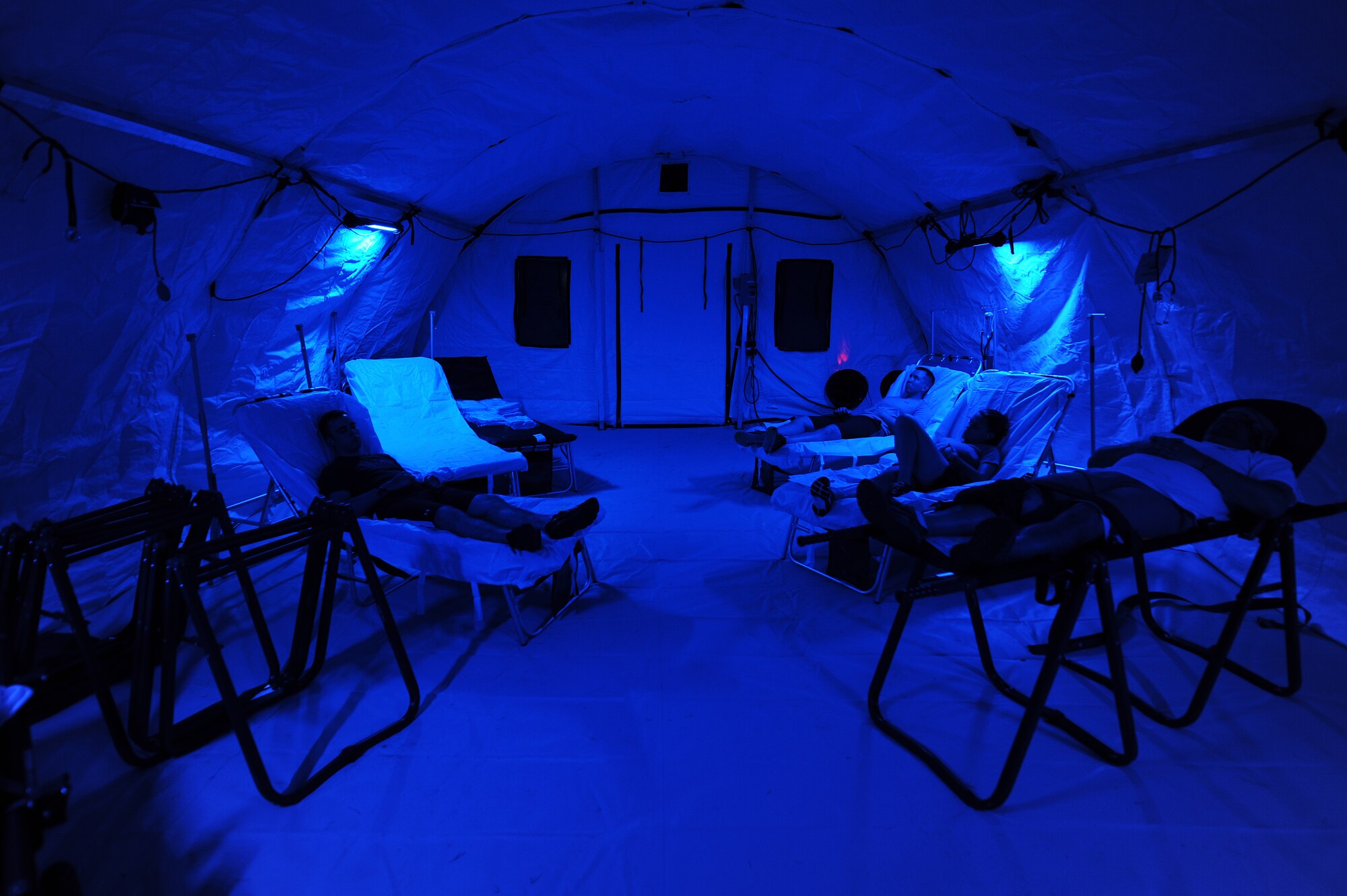 Airmen with simulated injuries rest in an En-Route Patient Staging System during an exercise on Kadena Air Base, Japan, Aug. 18, 2015. An ERPSS can be up and running in a matter of hours and is only used during times of war or other contingencies. It is a temporary facility erected to house patients and allow medical professionals to care for them before they are medically evacuated to a better-equipped facility in a safer area. (U.S. Air Force photo by Airman 1st Class Zade C. Vadnais)