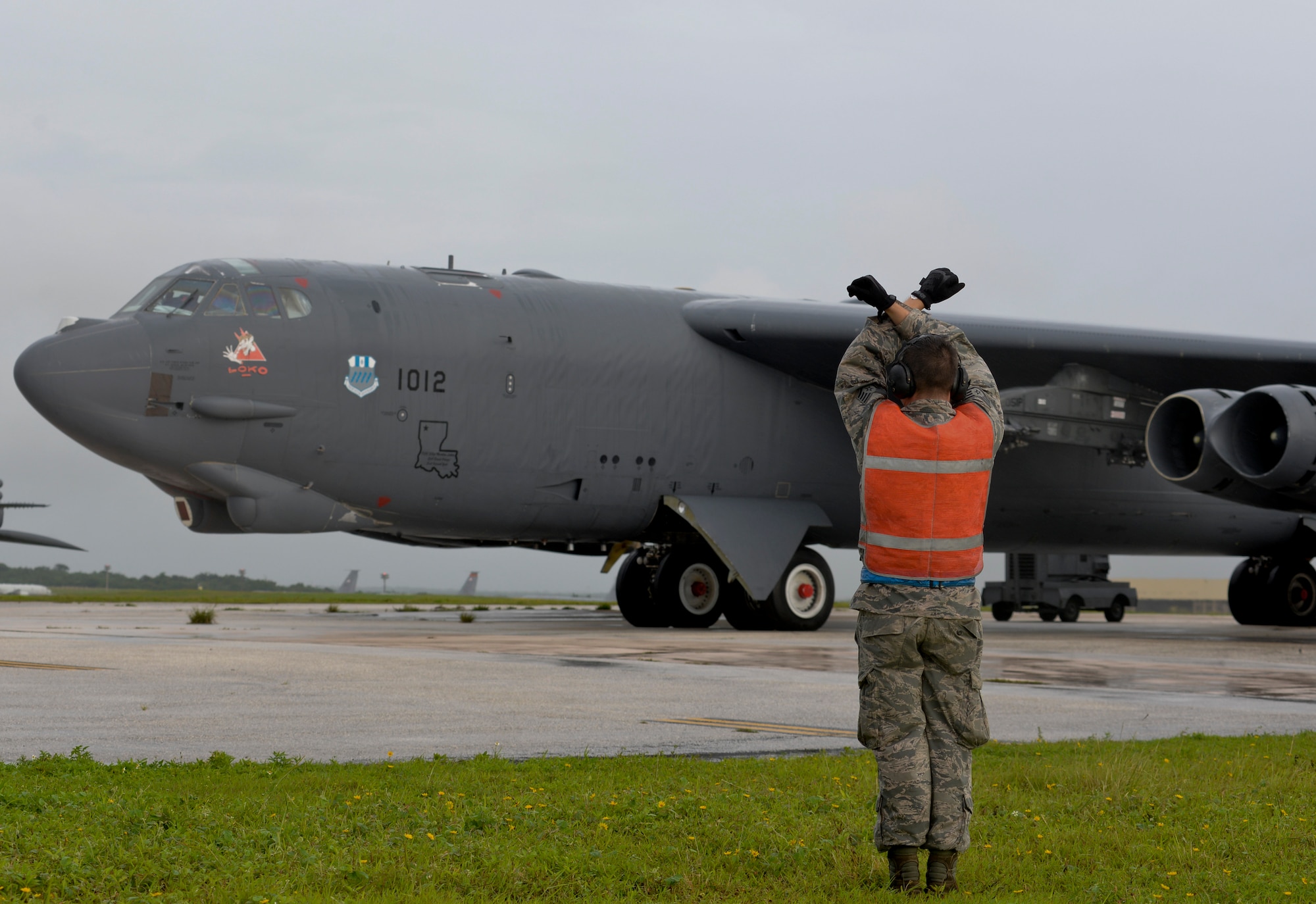 An Airman from the 20th Expeditionary Aircraft Maintenance Squadron prepares to taxi a B-52 Stratofortress Aug. 22, 2015, at Andersen Air Force Base, Guam. Bomber crews with the 20th EBS from Barksdale Air Force Base, Louisiana, are part of U.S. Pacific Command’s Continuous Bomber Presence and support ongoing operations in the Indo-Asia-Pacific region. (U.S. Air Force photo by Staff Sgt. Robert Hicks/Released)