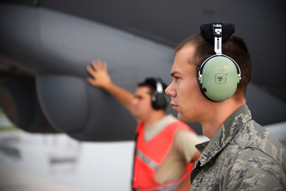 Senior Airmen Logan Turner, right, and Taylor Giordano, B-52 Stratofortress crew chiefs assigned to the 20th Expeditionary Aircraft Maintenance Squadron, observe their aircraft during preflight operations Aug. 22, 2015, at Andersen Air Force Base , Guam. Bomber crews with the 20th Expeditionary Bomb Squadron are part of U.S. Pacific Command’s continuous bomber presence and support ongoing operations in the Indo-Asia-Pacific region. (U.S. Air Force photo by Staff Sgt. Alexander W. Riedel/Released)