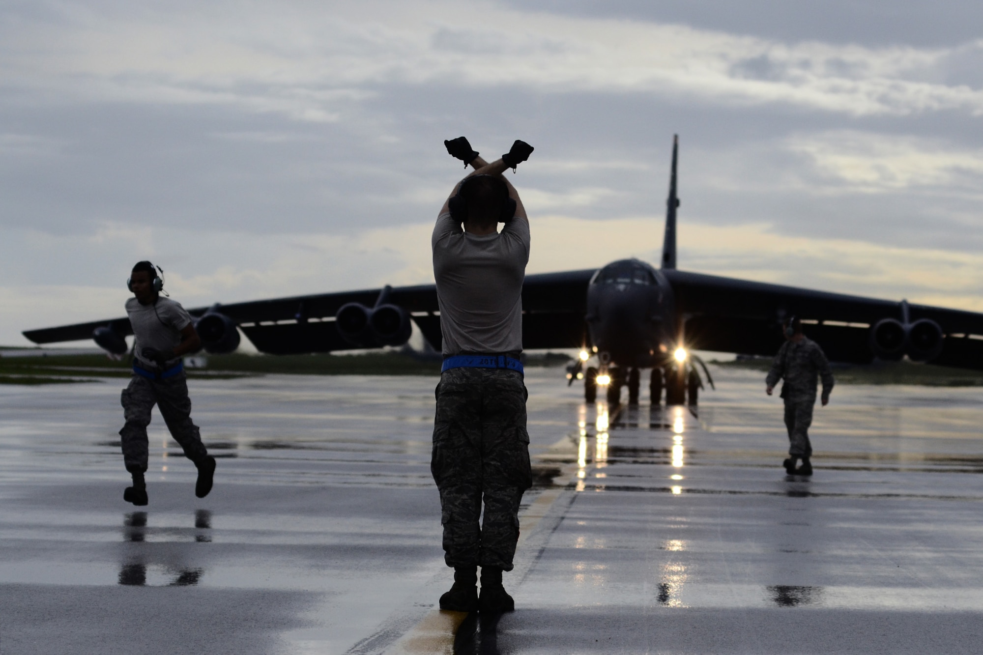 A B-52 Stratofortress crew chief assigned to the 20th Expeditionary Aircraft Maintenance Squadron marshals his aircraft on the flightline Aug. 22, 2015, at Andersen Air Force Base, Guam. Bomber crews with the 20th Expeditionary Bomb Squadron are part of U.S. Pacific Command’s continuous bomber presence and support ongoing operations in the Indo-Asia-Pacific region. (U.S. Air Force photo by Staff Sgt. Alexander W. Riedel/Released)