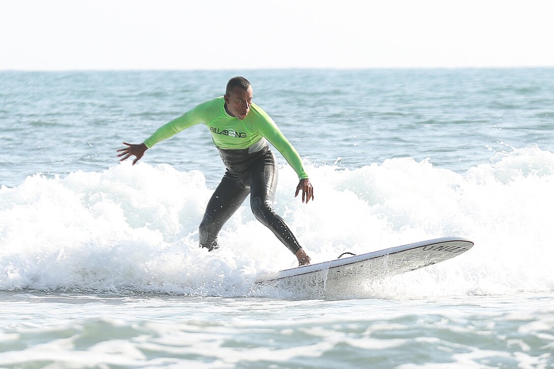 Marine Corps Master Sgt. Hugo L. Gonzalez surfs with Operation Amped at San Onofre Beach, Calif., Aug. 21. Operation Amped, an annual surfing event open to Wounded Warriors and their families, aims to share the healing potential of surfing with seriously ill, injured, or disabled U.S. military veterans and their families. U.S. Marine Corps photo by Cpl. Asia J. Sorenson
