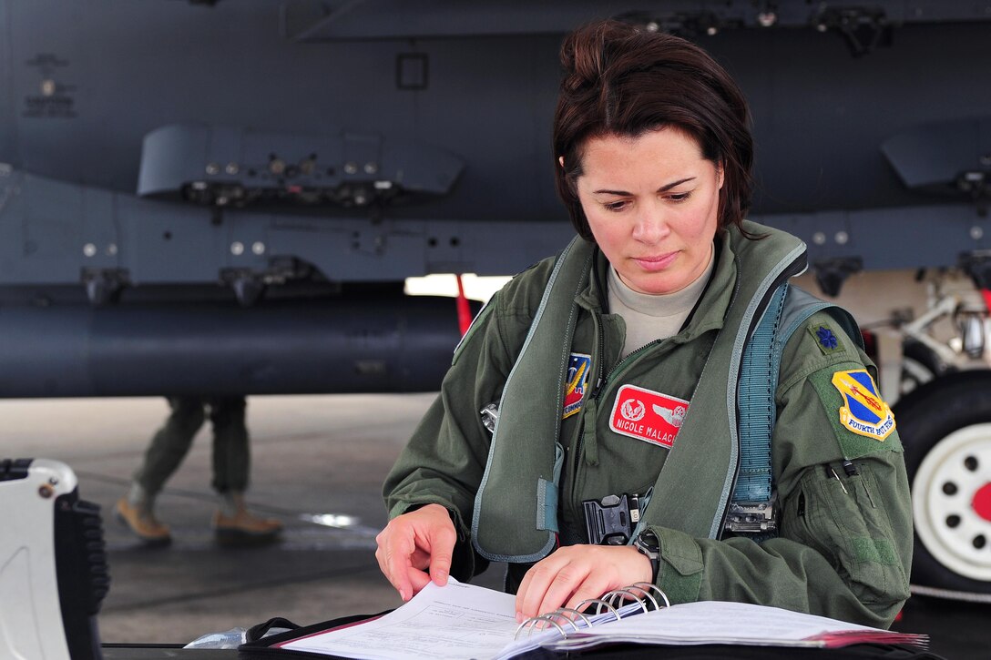 U.S. Air Force Lt. Col. Nicole Malachowski reviews aircraft logs during a preflight inspection on Seymour Johnson Air Force Base, N.C., May 8, 2013. Malachowski commands the 333rd Fighter Squadron. U.S. Air Force photo by Airman 1st Class John Nieves Camacho
