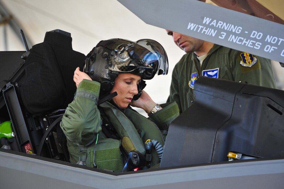 Air Force Lt. Col. Christine Mau puts on her helmet before taking her first flight in the F-35A aircraft on Eglin Air Force Base, Fla., May 5, 2015. Mau is deputy commander for the 33rd Operations Group. Mau, who previously flew F-15E Strike Eagles, made history as the first female F-35 pilot in the program. U.S. Air Force photo by Staff Sgt. Marleah Robertson