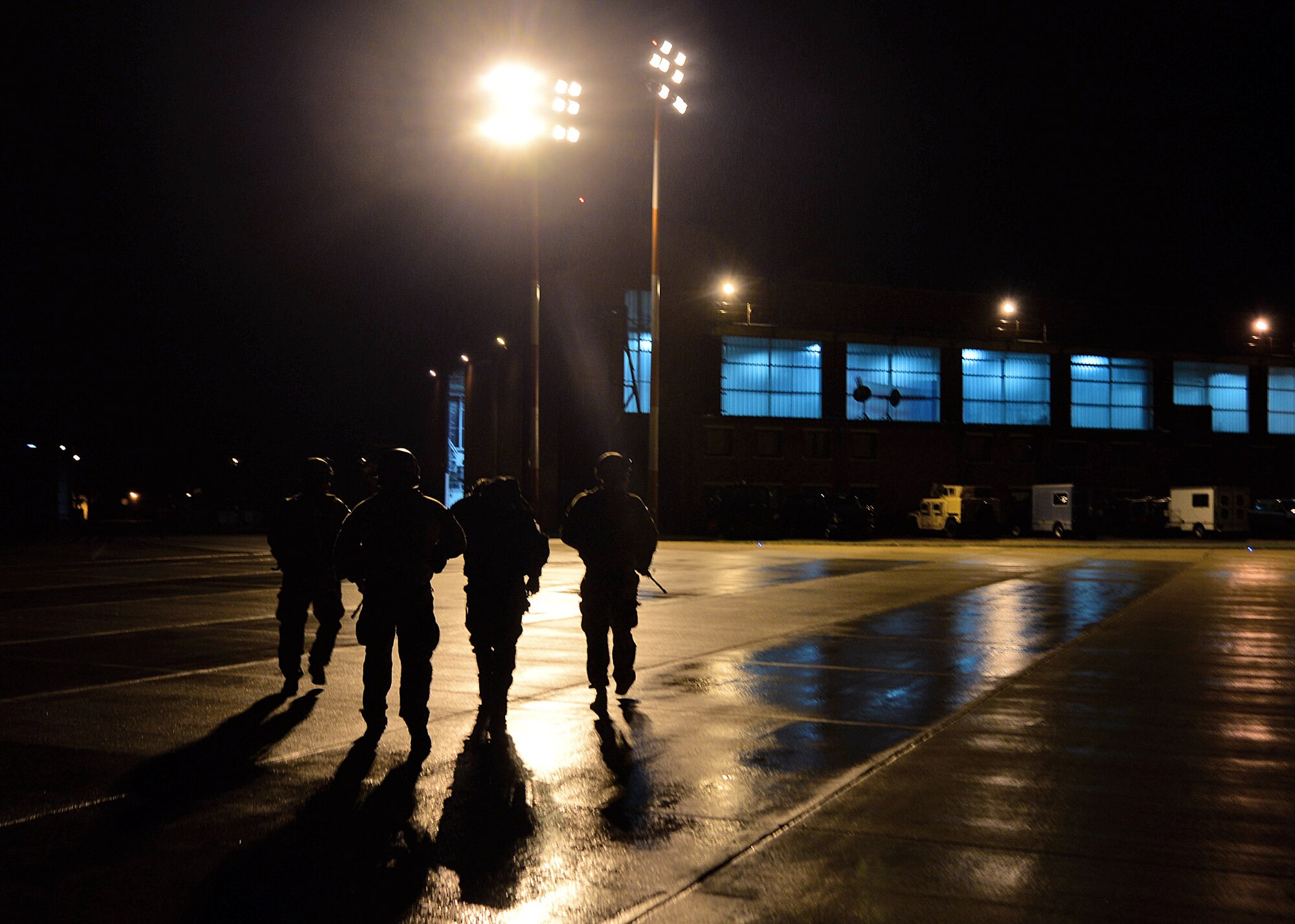 U.S. Air Force Airmen from the 352nd Special Operations Support Squadron Deployed Aircraft Ground Response Element Team escort a survivor to a Phase One reintegration facility on base during an exercise Aug. 19, 2015, on RAF Mildenhall, England. Exercise Jackal Stone’s mission was to conduct a long range operation recovering an isolated DoD Contractor. (U.S. Air Force photo by Senior Airman Christine Halan/Released)