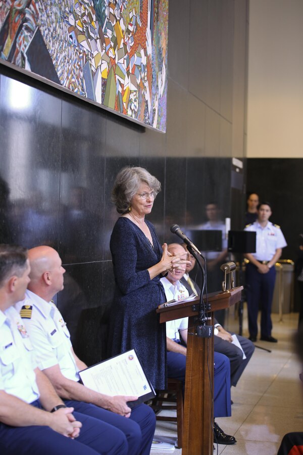 Louisiana artist Dale Fairbanks addresses the audience at the dedication ceremony for her painting “Rescue Me” at the Hale Boggs Federal Building in New Orleans, La.,  Aug. 25, 2015. “Rescue Me” is based off of televised imagery of an MH-65 Dolphin helicopter rescuing stranded citizens in New Orleans’ Ninth Ward in the aftermath of Hurricane Katrina. The dedication ceremony was one of dozens of events this week commemorates the 10th anniversary of Hurricane Katrina on Aug. 29, 2015. 