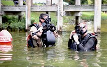 Gunnery Sgt. Zachary Burgart (left), project officer for amphibious reconnaissance equipment, and Master Sgt. Brad Colbert, project officer for small craft, MK25 closed-circuit underwater breathing apparatus. The system is a closed-circuit underwater breathing apparatus that allows its users to remain concealed in covert operations.