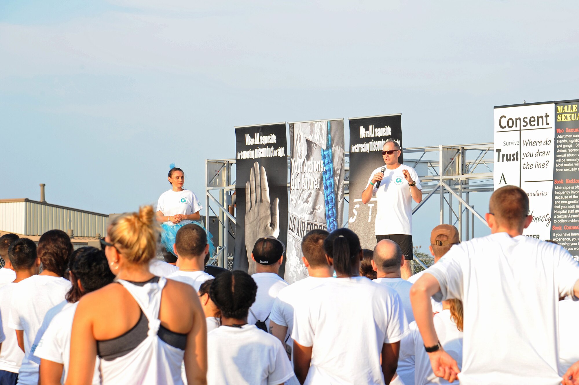 U.S. Air Force Col. Michael L. Downs, 17th Training Wing Commander, speaks to the Sexual Assault Prevention and Response 5K Color Race participants at Kiowa Trail on Goodfellow Air Force Base, Texas, Aug. 22. 2015. The SAPR Office hosts the event every year to promote sexual assault prevention awareness. (U.S. Air Force photo by Airman Caelynn Ferguson/Released)