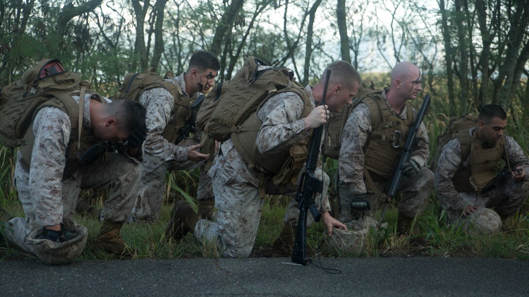 Marines in Sergeants Course take a knee and rest after hiking up Radio Hill aboard Marine Corps Base Hawaii, Aug. 19, 2015. The day’s events consisted of patrolling across the base while engaging in various training scenarios. Sergeants Course is a vital part of professional military education for any Marine and helps to maintain the standards amongst the NCOs of the Marine Corps. The course supports MCB Hawaii’s mission, which is to provide facilities, programs and services in direct support of units, individuals and families to enhance and sustain combat readiness for all operating forces and tenant organizations aboard the installation. 