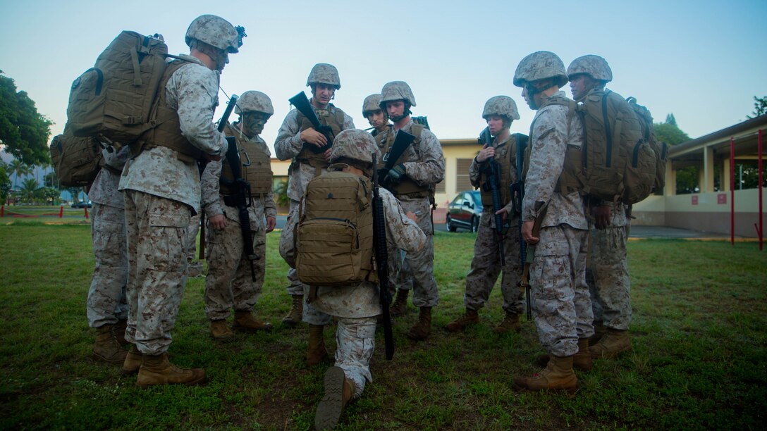 Sgt. Joshua Flores, the training noncommissioned officer of Combat Logistics Battalion 3, briefs his squad before they set out to start the first scenario of the day aboard Marine Corps Base Hawaii Aug. 19, 2015. The day’s events consisted of patrolling across the base while taking on various situations. Sergeants Course is a vital part of professional military education for any Marine and helps to maintain the standards amongst the NCOs of the Marine Corps. The course supports MCB Hawaii’s mission, which is to provide facilities, programs and services in direct support of units, individuals and families to enhance and sustain combat readiness for all operating forces and tenant organizations aboard the installation.