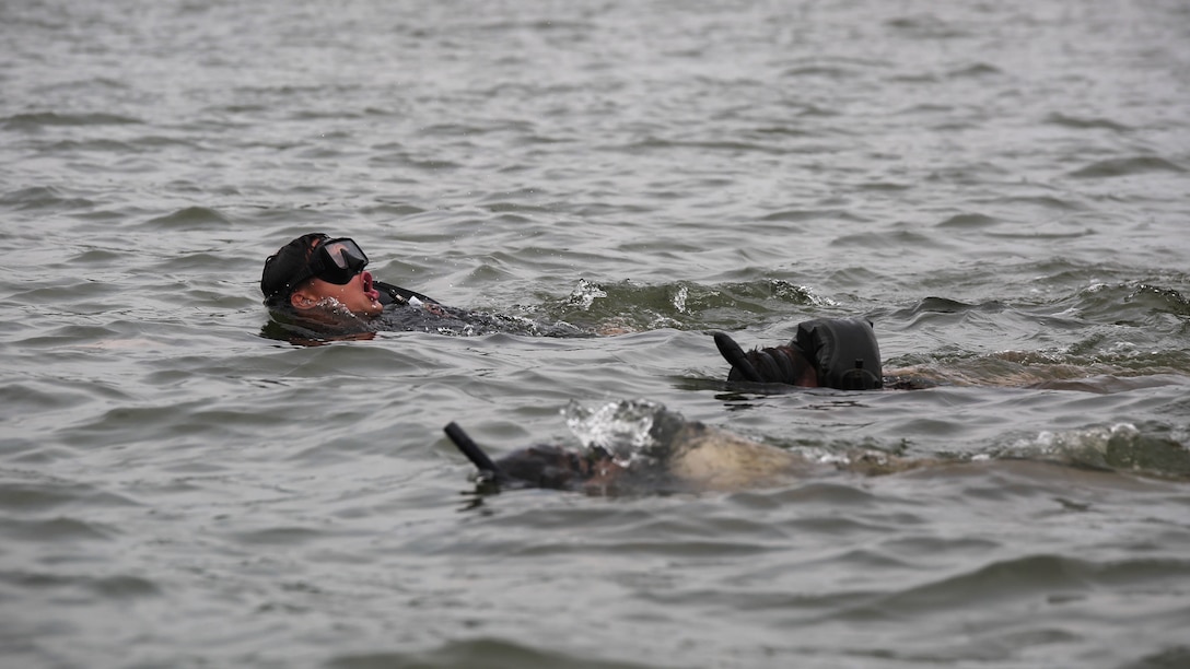 Marines with 2nd Reconnaissance Battalion fight the current as they try to complete a 1,000 meter open water fin training aboard Camp Lejeune, N.C., Aug. 18, 2015. The Marines are training in preparation for the Marine Combatant Diver Course at the Naval Diving and Salvage Training Center, Panama City, Fla. 