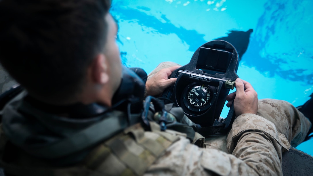 A Marine with 2nd Reconnaissance Battalion conducts a final check of his gear as he prepares to enter the water aboard Camp Lejeune, N.C., Aug. 18, 2015. Marines within the unit are taking part in a preparatory course before they head to the Marine Combatant Diver Course at the Naval Diving and Salvage Training Center, Panama City, Fla., later this year. 