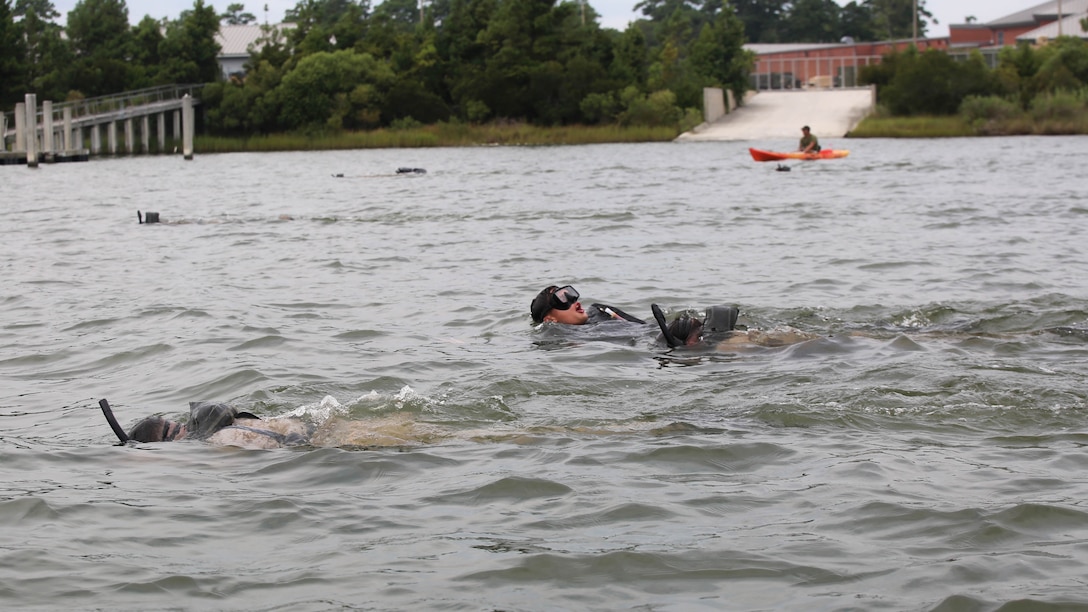 Marines with 2nd Reconnaissance Battalion swim against the current as they try to complete a 1,000 meter open water fin training aboard Camp Lejeune, N.C., Aug. 18, 2015. The Marines were conducting the swim as part of a pre-dive course being held Aug. 17 and 18. During this portion of the course Marines were given a 30-minute time limit to complete the swim. 
