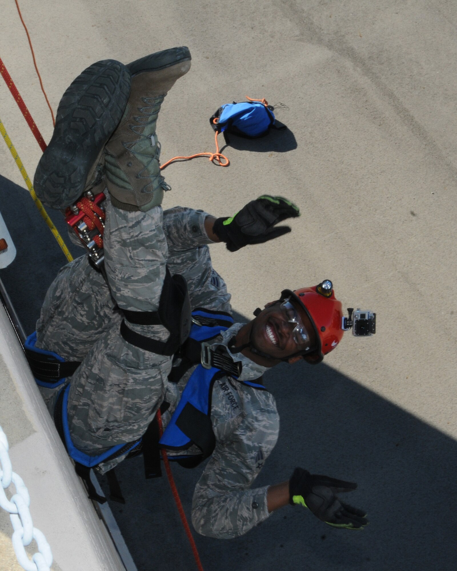 Tech. Sgt. Tim Wertz, a firefighter for the 910th Civil Engineer Squadron, readies Senior Airman Jamar Hudson, also a firefighter for the Civil Engineer Squadron, for his attempt at rappelling here, August 1, 2015. Rappelling is part of the firefighters’ required training. (U.S. Air Force photo/ TSgt. Rick Lisum)