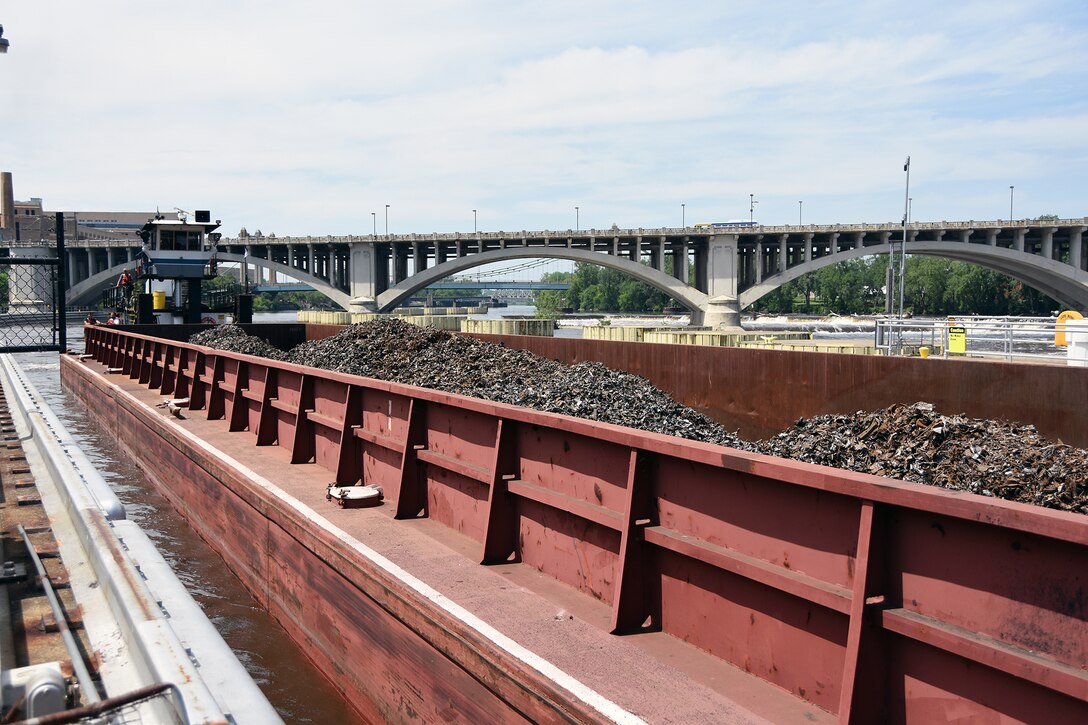 Upper River Services’ Motor Vessel Becky Sue locks through Upper St. Anthony Falls lock in downtown Minneapolis at 2:45 p.m. on June 9, 2015, with two barges loaded with scrap metal. This marked the final lockage by a commercial tow at the lock.  The Water Resources Reform and Development Act of 2014 directed the Corps to close the lock to navigation by June 10, 2015.