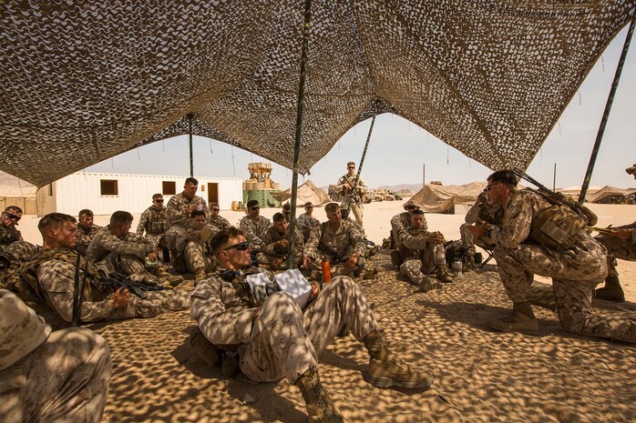 U.S. Marine Corps 1st Lt. Brandon Recker, platoon commander with Company A, 1st Battalion, 7th Marine Regiment, describes the importance of security force operations as a part of Large Scale Exercise (LSE) at Marine Corps Air Ground Combat Center Twentynine Palms, Calif., Aug. 18, 2015. LSE is a joint forces exercise conducted at the brigade level designed to enable live, virtual, and constructive training for participating units and allows participating nations to strengthen partnerships and their ability to operate together. (U.S. Marine Corps photo by Lance Cpl. Clarence A. Leake/Released)