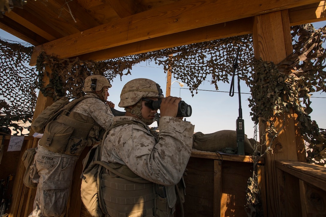 U.S. Marine Corps Lance Cpl. Adam Amato with Company A, 1st Battalion, 7th Marine Regiment, looks through binoculars scanning for enemy movements while conducting security force operations as a part of Large Scale Exercise (LSE) at Marine Corps Air Ground Combat Center Twentynine Palms, Calif., Aug. 18, 2015. LSE is a joint forces exercise conducted at the brigade level designed to enable live, virtual, and constructive training for participating units and allows participating nations to strengthen partnerships and their ability to operate together. (U.S. Marine Corps photo by Lance Cpl. Clarence A. Leake/Released)