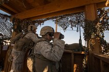U.S. Marine Corps Lance Cpl. Adam Amato with Company A, 1st Battalion, 7th Marine Regiment, looks through binoculars scanning for enemy movements while conducting security force operations as a part of Large Scale Exercise (LSE) at Marine Corps Air Ground Combat Center Twentynine Palms, Calif., Aug. 18, 2015. LSE is a joint forces exercise conducted at the brigade level designed to enable live, virtual, and constructive training for participating units and allows participating nations to strengthen partnerships and their ability to operate together. (U.S. Marine Corps photo by Lance Cpl. Clarence A. Leake/Released)