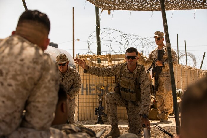 U.S. Marine Corps 1st Lt. Brandon Recker, platoon commander, Company A, 1st Battalion, 7th Marine Regiment, describes the importance of security force operations during part of Large Scale Exercise (LSE) at Marine Corps Air Ground Combat Center Twentynine Palms, Calif., Aug. 18, 2015. LSE is a joint forces exercise conducted at the brigade level designed to enable live, virtual, and constructive training for participating units and allows participating nations to strengthen partnerships and their ability to operate together. (U.S. Marine Corps photo by Lance Cpl. Clarence A. Leake/Released)