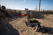 U.S. Marines with Company A, 1st Battalion, 7th Marine Regiment, search role players while conducting security force operations as a part of Large Scale Exercise (LSE) at Marine Corps Air Ground Combat Center Twentynine Palms, Calif., Aug. 18, 2015. LSE is a joint forces exercise conducted at the brigade level designed to enable live, virtual, and constructive training for participating units and allows participating nations to strengthen partnerships and their ability to operate together.(U.S. Marine Corps photo by Lance Cpl. Clarence A. Leake/Released)