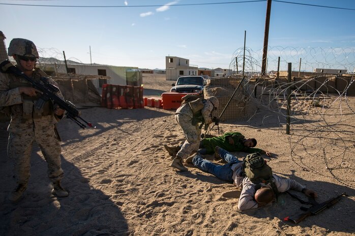 U.S. Marines with Company A, 1st Battalion, 7th Marine Regiment, search role players while conducting security force operations as a part of Large Scale Exercise (LSE) at Marine Corps Air Ground Combat Center Twentynine Palms, Calif., Aug. 18, 2015. LSE is a joint forces exercise conducted at the brigade level designed to enable live, virtual, and constructive training for participating units and allows participating nations to strengthen partnerships and their ability to operate together.(U.S. Marine Corps photo by Lance Cpl. Clarence A. Leake/Released)