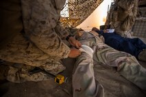U.S. Navy Seaman Apprentice Isaac Montalvo, hospitalman with Company A, 1st Battalion, 7th Marine Regiment, implements simulated combat life saver procedures during Large Scale Exercise (LSE) at Marine Corps Air Ground Combat Center Twentynine Palms, Calif., Aug. 18, 2015. LSE is a joint forces exercise conducted at the brigade level designed to enable live, virtual, and constructive training for participating units and allows participating nations to strengthen partnerships and their ability to operate together. (U.S. Marine Corps photo by Lance Cpl. Clarence A. Leake/Released)
