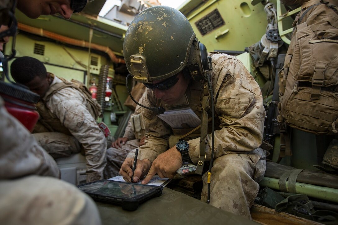 U.S. Marine Corps 1st Lt. Joseph McKee, a fire integration support team (FiST) leader with Company C, 1st Battalion, 7th Marine Regiment annotates grid coordinates during Large Scale Exercise (LSE) at Marine Corps Air Ground Combat Center Twentynine Palms, Calif., Aug. 16,  2015. LSE is a joint forces exercise conducted at the brigade level designed to enable live, virtual, and constructive training for participating units and allows participating nations to strengthen partnerships and their ability to operate together. (U.S. Marine Corps photo by Lance Cpl. Clarence A. Leake/Released)