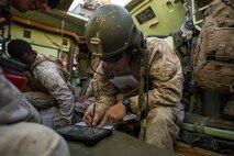 U.S. Marine Corps 1st Lt. Joseph McKee, a fire integration support team (FiST) leader with Company C, 1st Battalion, 7th Marine Regiment annotates grid coordinates during Large Scale Exercise (LSE) at Marine Corps Air Ground Combat Center Twentynine Palms, Calif., Aug. 16,  2015. LSE is a joint forces exercise conducted at the brigade level designed to enable live, virtual, and constructive training for participating units and allows participating nations to strengthen partnerships and their ability to operate together. (U.S. Marine Corps photo by Lance Cpl. Clarence A. Leake/Released)
