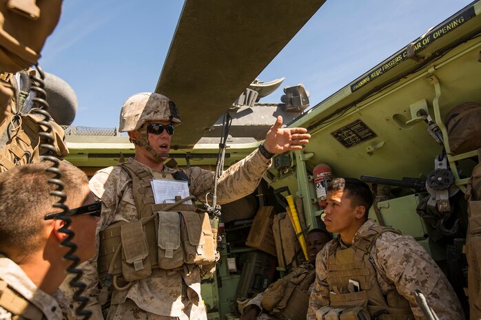 U.S. Marine Corps 1st Lt. Joseph McKee, a fire integrations support team (FiST) leader with Company C, 1st Battalion, 7th Marine Regiment, discusses the plan of attack before conducting a FiST exercise as a part of Large Scale Exercise (LSE) at Marine Corps Air Ground Combat Center Twentynine Palms, Calif., Aug. 16, 2015. LSE is a joint forces exercise conducted at the brigade level designed to enable live, virtual, and constructive training for participating units and allows participating nations to strengthen partnerships and their ability to operate together. (U.S. Marine Corps photo by Lance Cpl. Clarence A. Leake/Released)