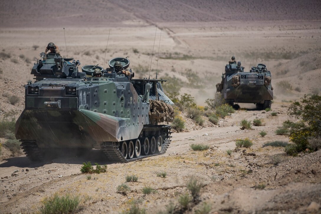 U.S. Marine Corps amphibious assault vehicles, in support of Large Scale Exercise (LSE) at Marine Corps Air Ground Combat Center Twentynine Palms, Calif., Aug. 16, 2015, maneuver toward assault positions. LSE is a joint forces exercise conducted at the brigade level designed to enable live, virtual, and constructive training for participating units and allows participating nations to strengthen partnerships and their ability to operate together. (U.S. Marine Corps photo by Lance Cpl. Clarence A. Leake/Released)