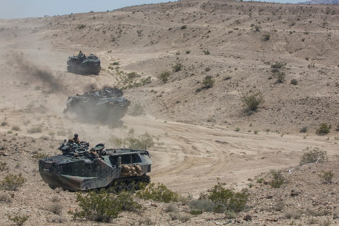 U.S. Marine Corps amphibious assault vehicles, in support of Large Scale Exercise (LSE) at Marine Corps Air Ground Combat Center Twentynine Palms, Calif., Aug.  16, 2015, maneuver toward assault positions. LSE is a joint forces exercise conducted at the brigade level designed to enable live, virtual, and constructive training for participating units and allows participating nations to strengthen partnerships and their ability to operate together. (U.S. Marine Corps photo by Lance Cpl. Clarence A. Leake/Released)