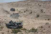 U.S. Marine Corps amphibious assault vehicles, in support of Large Scale Exercise (LSE) at Marine Corps Air Ground Combat Center Twentynine Palms, Calif., Aug.  16, 2015, maneuver toward assault positions. LSE is a joint forces exercise conducted at the brigade level designed to enable live, virtual, and constructive training for participating units and allows participating nations to strengthen partnerships and their ability to operate together. (U.S. Marine Corps photo by Lance Cpl. Clarence A. Leake/Released)