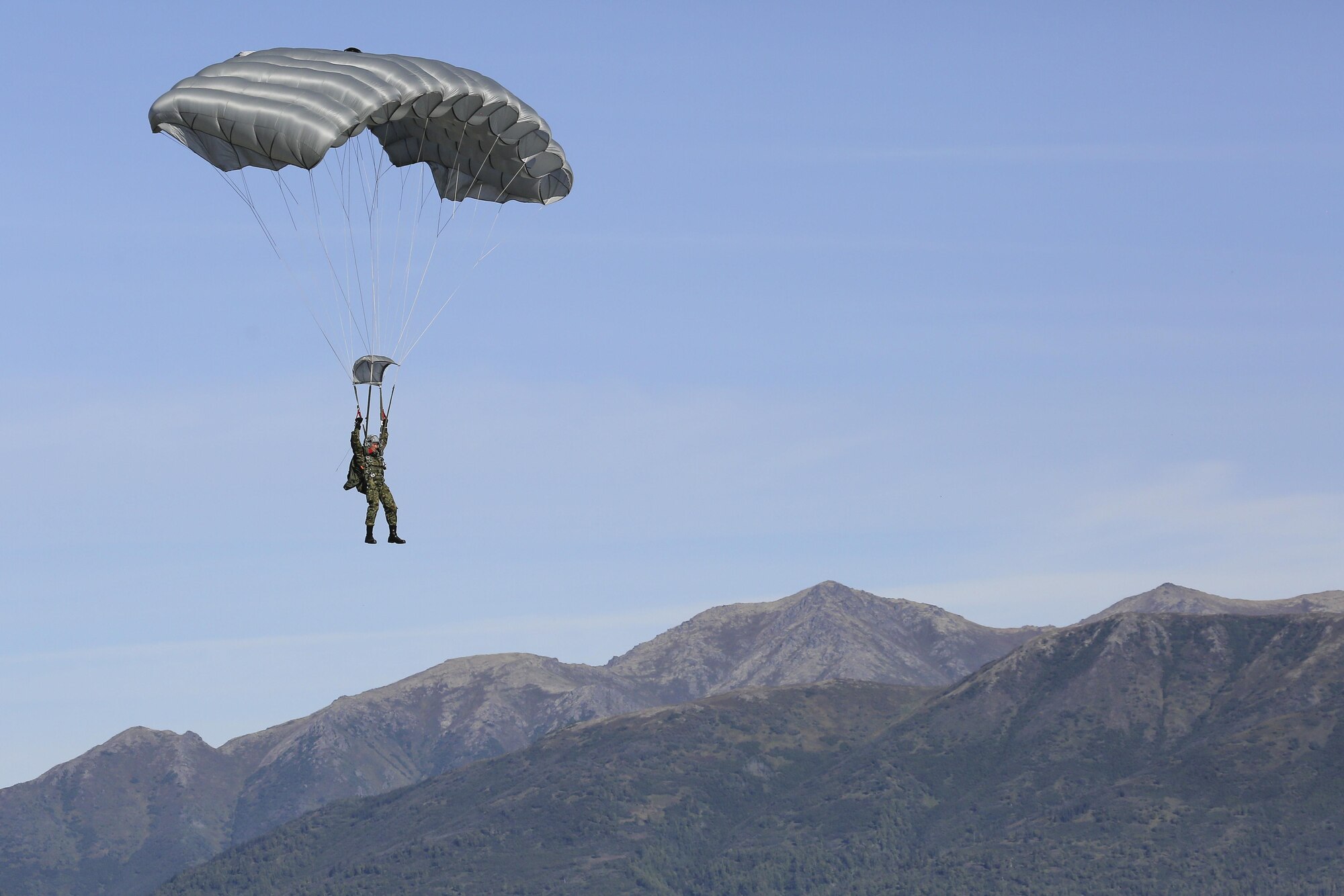 Japanese Ground Self-Defense Force Sgt. Kuniaki Iwakura, from Chiba prefecture, descends during a practice high altitude-low opening jump over Malemute drop zone, Joint Base Elmendorf-Richardson, Alaska, Aug. 24, 2015. JGSDF and U.S. Army paratroopers conducted the practice jump utilizing Royal Australian and U.S. Air Force aircraft as part of Pacific Airlift Rally 2015, a biennial, multilateral tactical military symposium designed to enhance military airlift interoperability and cooperation between nations of the Pacific region for future humanitarian missions. (U.S. Air Force photo by Alejandro Pena/Released)