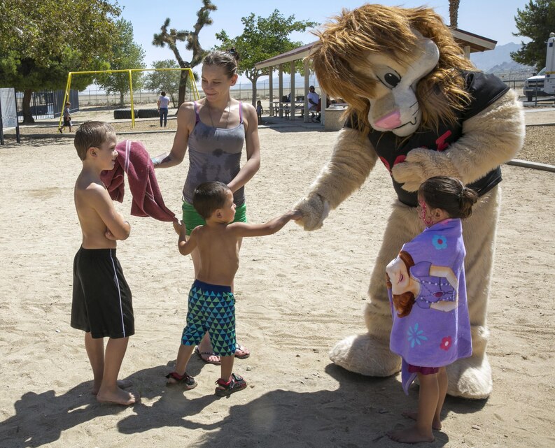 The Provost Marshal’s Office’s Drug Abuse Resistance Education Lion, Daren, interacts with Morongo Basin children at the Joshua Tree Summer Splash event at the Joshua Tree Community Center, Aug. 22, 2015. (Official Marine Corps photo by Pfc. Levi Schultz/Released)