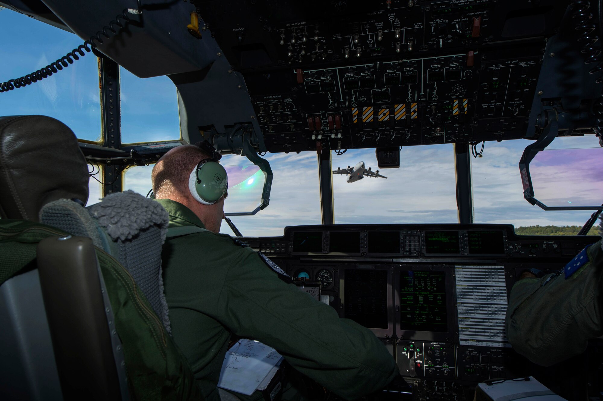 Royal Air Force Flight Lt. Graeme Hunt, a British C-130J Super Hercules pilot on exchange with the Royal Australian Air Force's No. 37 Squadron holds short of an intersecting runway while a C-17 Globemaster III performs a touch and go during Pacific Airlift Rally on August 25, 2015. Pacific Airlift Rally is a biennial, military airlift symposium sponsored by Pacific Air Forces for nations in the Indo-Asia-Pacific region. This year marks the 10th iteration of the PAR exercise series, which began in 1997. (U.S. Air Force photo/Staff Sgt. Sheila deVera)
