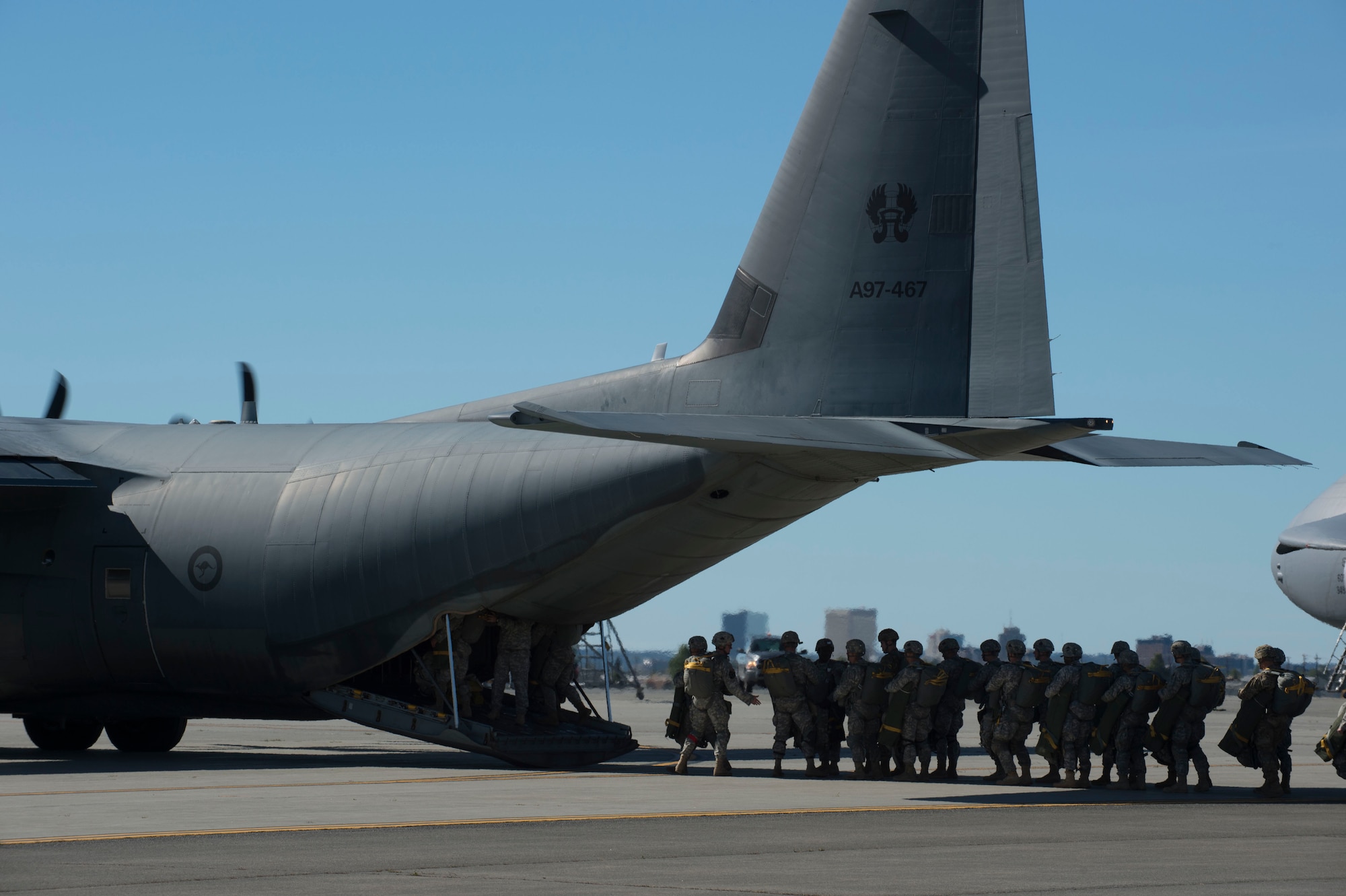 Paratroopers assigned to 1st Battalion (Airborne), 501st Infantry Regiment, 4th Infantry Brigade Combat Team (Airborne), 25th Infantry Division, U.S. Army Alaska prepare to board a C-130J Super Hercules, assigned to the Royal Australian Air Force No. 37 Squadron on Joint Base Elmendorf-Richardson, Alaska, Aug. 24, 2015. Japanese Ground Self-Defense Force and U.S. Army paratroopers conducted a parachute jump from Royal Australian and U.S. Air Force aircraft as part of Pacific Airlift Rally 2015, a biennial, multilateral tactical military symposium designed to enhance military airlift interoperability and cooperation between nations of the Pacific region for future humanitarian missions. (U.S. Air Force photo/Staff Sgt. Sheila deVera)
