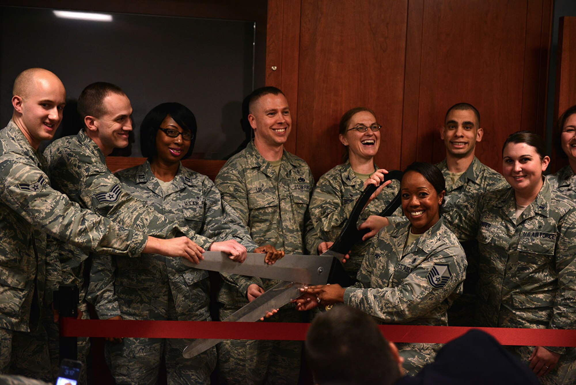 Airmen from each available rank in the Behavioral Health Unit, cut a ceremonial ribbon Aug. 25, 2015 as the first BHU to be opened in PACAF. The BHU's mission is to treat all active duty servicemembers with acute, non-substance abuse diagnosis of depression, anxiety, post-traumatic stress disorder, and other mental disorders. (U.S. Air Force photo/ Airman 1st class Kyle Johnson)