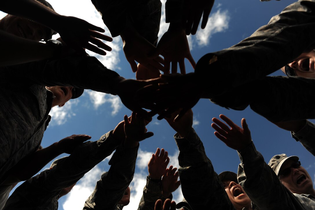 Personnel from the 28th Medical Group celebrate the completion of their field training day at Ellsworth Air Force Base, S.D., Aug. 19, 2015. The exercise included scenarios designed to help Airmen refresh medical skills used in deployed environments and crisis situations. (U.S. Air Force photo by Airman Sadie Colbert/Released)