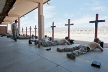 Participants in the M4 rifle qualification course lay in the prone position in preparation to firing their weapons at the 99th Security Forces Squadron Combat Arms Training and Maintenance firing range at Nellis Air Force Base, Nev., Aug. 18, 2015. CATM provides weapons training for  the M4, M9, M240, M249 and M203. (U.S. Air Force photo by Airman 1st Class Jake Carter)