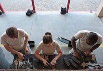 Participants in the M4 rifle qualification course load ammunition into their respective cartridges at the 99th Security Forces Squadron Combat Arms Training and Maintenance firing range on Nellis Air Force Base, Nev., Aug. 18, 2015. Airmen participated in the qualification course in preparation for either a deployment, permanent change of station move, or part of yearly training. (U.S. Air Force photo by Airman 1st Class Jake Carter)
