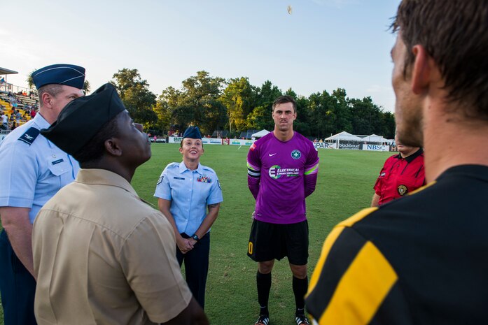 Col. Robert Lyman, Joint Base Charleston commander, SSgt. Samantha Varden, 437th Airlift Wing command chief's executive, and Petty Officer 2nd Class Victor Nyarko, 628th Civil Engineer Squadron, perform a coin toss with team captains and ball boys prior to the Charleston Battery soccer team's military appreciation night held at Blackbaud Stadium on Daniel Island, S.C., Aug. 17, 2015. The team wore camouflage uniforms and provided free tickets to any service member, retiree or spouse who presented a military ID. (U.S. Air Force photo/Senior Airman George Goslin)