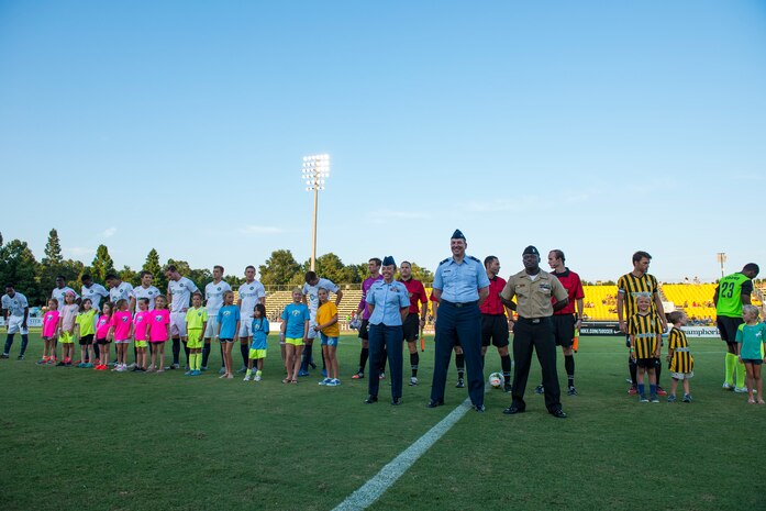 Col. Robert Lyman, Joint Base Charleston commander, SSgt. Samantha Varden, 437th Airlift Wing command chief's executive, and Petty Officer 2nd Class Victor Nyarko, 628th Civil Engineer Squadron, perform a coin toss with team captains and ball boys prior to the Charleston Battery soccer team's military appreciation night held at Blackbaud Stadium on Daniel Island, S.C., Aug. 15, 2015. The team wore camouflage uniforms and provided free tickets to any service member, retiree or spouse who presented a military ID. (U.S. Air Force photo/Senior Airman George Goslin)