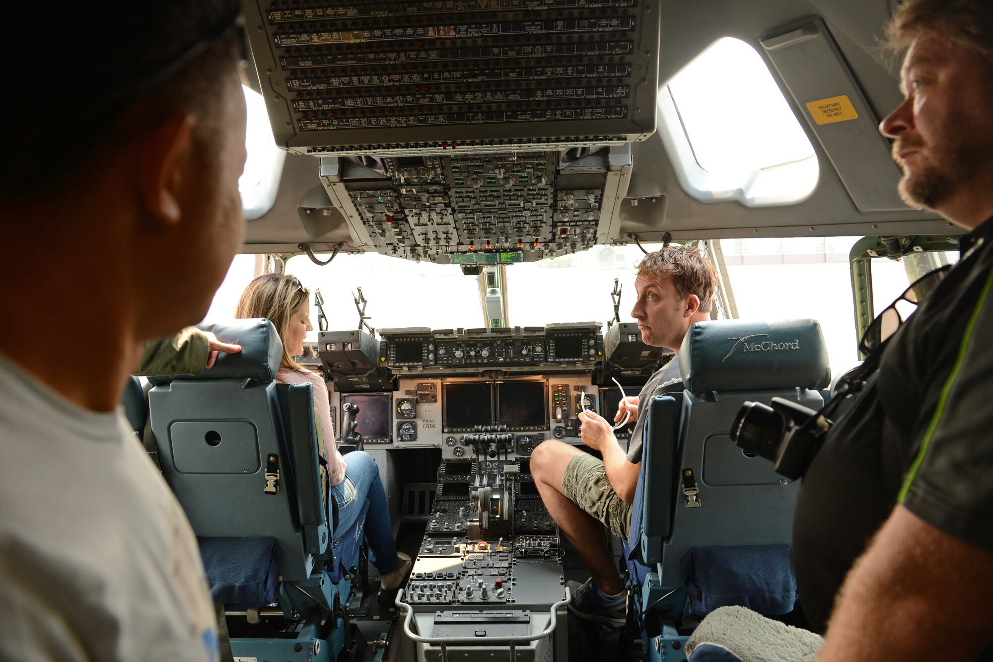 Members from the McChord Pathfinder look around the flight deck of a C-17 Globemaster III, Aug. 22, 2015, at Joint Base Lewis-McChord, Wash. The members from the McChord Pathfinder, a group of retired security forces Airmen that were once stationed at JBLM, were able to talk to a C-17 pilot and loadmaster about the aircraft during their tour. (U.S. Air Force photo/Airman 1st Class Keoni Chavarria)