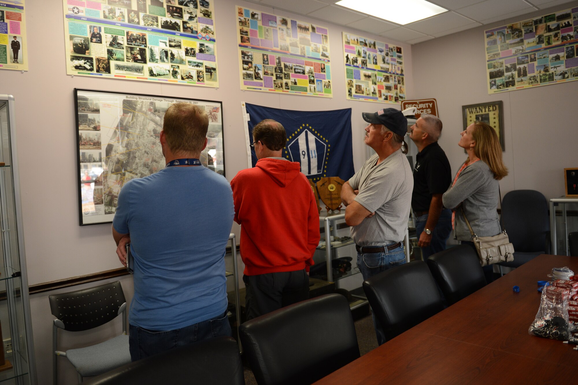 Members from the McChord Pathfinder look at pictures and posters Aug. 22, 2015, in the 627th Security Forces Squadron heritage room at Joint Base Lewis-McChord, Wash. The group, which is comprised of retired security forces Airmen that were once stationed at JBLM, received a demonstration from the 627th SFS before touring a C-17 Globemaster III. (U.S. Air Force photo/Airman 1st Class Keoni Chavarria)